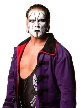 Close-up of WWE wrestler Sting wearing his signature white and black face paint and a purple trench coat with black buckle closures over a black wrestling singlet.