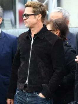 Three-quarter side angle of Brad Pitt wearing the open-neck black suede leather jacket paired with dark denim jeans and sunglasses.