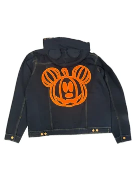 Flat lay rear view of the black Disney Mickey Mouse & Friends Halloween denim jacket, showing a large orange Mickey Mouse pumpkin graphic printed on the back panel and subtle ear shapes on the hood.