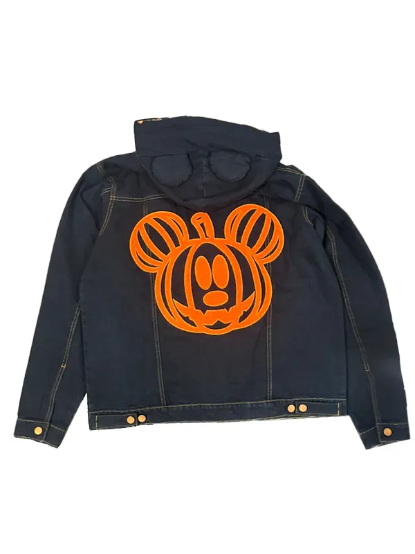 Flat lay rear view of the black Disney Mickey Mouse & Friends Halloween denim jacket, showing a large orange Mickey Mouse pumpkin graphic printed on the back panel and subtle ear shapes on the hood.
