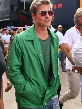 Brad Pitt walking outdoors wearing a vibrant bright green lightweight coach jacket with snap-button closure and a classic shirt collar, paired with aviator sunglasses.
