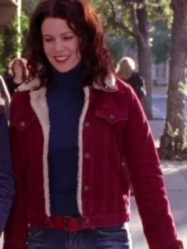 Medium shot of Lorelai Gilmore smiling on a sunny day in Stars Hollow wearing a maroon shearling-lined corduroy denim jacket.