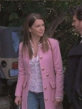 Lauren Graham as Lorelai Gilmore wearing a bright pink wool trench coat with gold buttons and flap pockets in Gilmore Girls.
