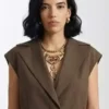 Front view of brown In the City Danielle Olivera Brown Vest highlighting the button and belted front closure.