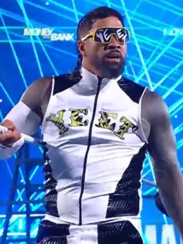 Medium shot of Jey Uso looking ahead, wearing yellow-rimmed "YEET" sunglasses and a white and black zippered vest with "YEET" printed in a yellow-and-black pattern across the chest.