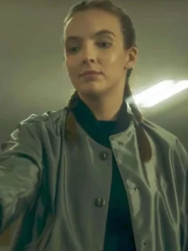 Up-close front view of Jodie Comer wearing the silver-grey satin jacket with a black rib-knit collar and metallic snap buttons.