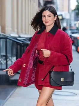 Full view of red cotton Monica Barbaro New York City 2026 Red Jacket highlighting three outside utility pockets.