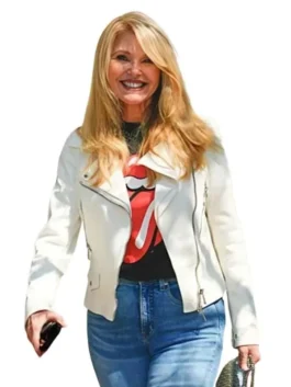 Christie Brinkley wearing a white leather biker jacket paired with jeans and a graphic tee in NYC