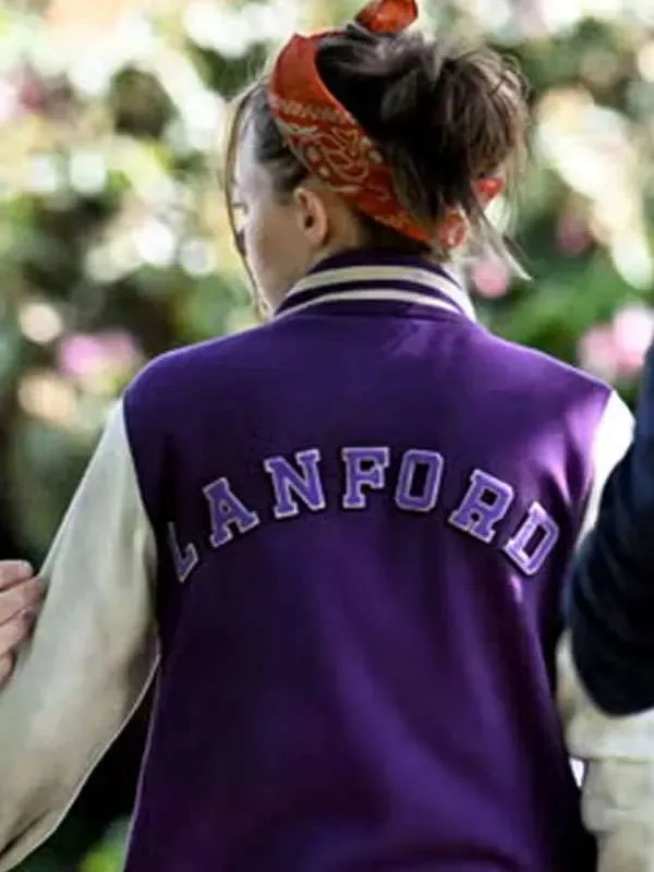 Back view of the Ellie de Lange purple varsity jacket from Run Away, featuring the word LANFORD embroidered in bold arched purple letters with a white border across the shoulders.