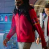 Karim Diane as a cadet in Star Trek: Starfleet Academy, wearing a casual red zip-up hoodie with multi-colored rank stripes on the sleeve while seated in a futuristic lounge.