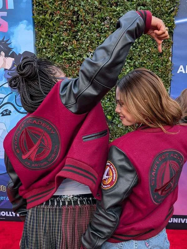 Cast members showing off the maroon Star Trek Starfleet Academy varsity jacket with black leather sleeves, featuring a large circular academy back patch and a matching emblem on the sleeve.