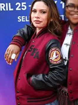 Close-up of a woman wearing a maroon Starfleet Academy varsity jacket with bold black "SFA" lettering on the chest and an embroidered sleeve patch.
