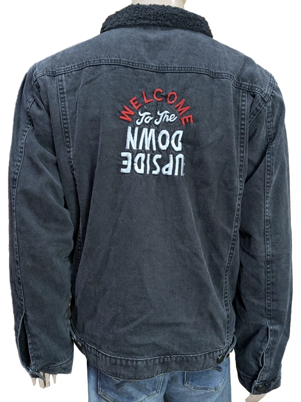 Rear view of the washed black Stranger Things denim jacket on a mannequin, showcasing the black sherpa collar and embroidered "Welcome to the Upside Down" text across the back.