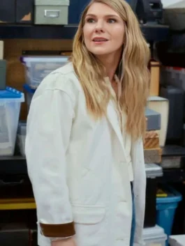Lily Rabe wearing an off-white cotton barn jacket with turned-up brown corduroy cuffs in a scene from Shrinking Season 3