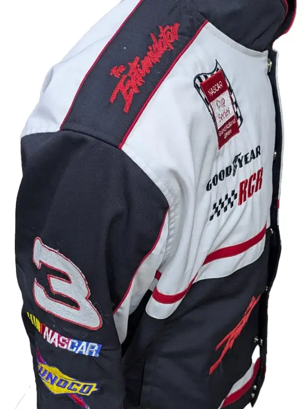 Close-up side view of the white and black racing jacket showcasing red embroidered "The Intimidator" text on the shoulder epaulet, a number 3 patch on the arm, and multiple sponsor logos.