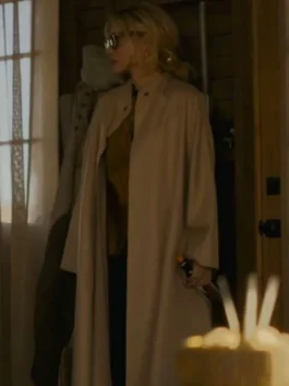Full-length shot of Michelle Pfeiffer indoors wearing a long beige wool coat over dark attire in The Madison.