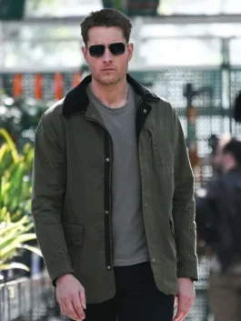Front view of Justin Hartley wearing sunglasses and the Colter Shaw Tracker S02 green cotton jacket outdoors.