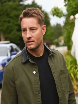 Close-up of Justin Hartley as Colter Shaw in Tracker wearing an olive green cotton jacket with a dark shirt underneath.