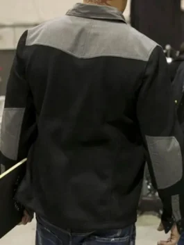 Rear view of the black and grey Xander Cage jacket, highlighting the contrast grey shoulder yoke and matching grey elbow patches on a black textured body.