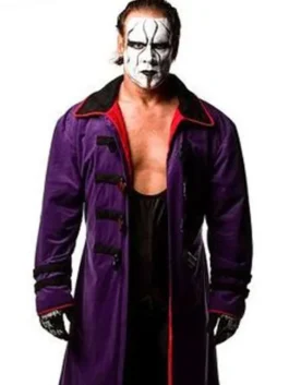 Full-length portrait of WWE wrestler Sting standing against a white background, wearing a long purple trench coat with a red lining, wide black collar, and matching black gloves.