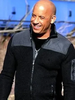 Front view of a smiling Vin Diesel wearing the black and grey zippered jacket with a stand-up collar and grey shoulder panels.